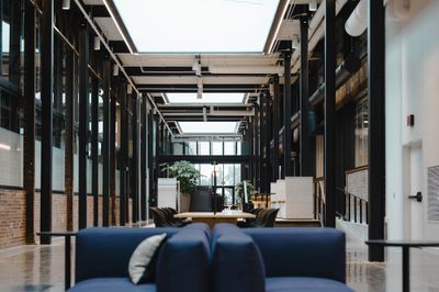 Skylit corridor with steel columns and lounge seating