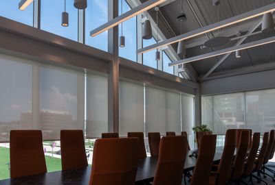Conference room with roller shades along the window wall