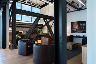 Lounge with leather chairs under exposed steel framing